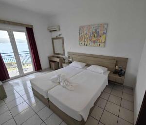 Postel nebo postele na pokoji v ubytování Andromeda Hotel