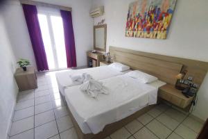 Postel nebo postele na pokoji v ubytování Andromeda Hotel