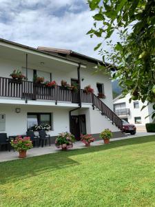 a white building with flowers on the balcony at APARTMA PANORAMA in Kobarid +71 photos