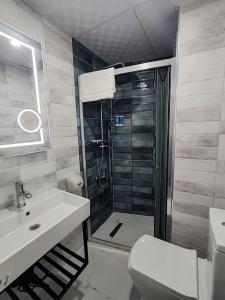 a bathroom with a shower and a sink and a toilet at Aim Bozcaada in Bozcaada