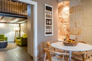 a dining room with a white table and chairs at B&B Morabella in Conversano