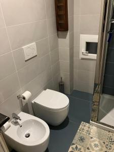 a bathroom with a toilet and a sink at Al Portico Private Apartment in Boffalora sopra Ticino