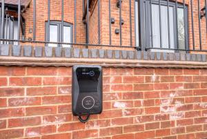 a cell phone on the side of a brick wall at Luxury Stockton Studio Rooms, Free WiFi & Parking in Stockton +11 photos