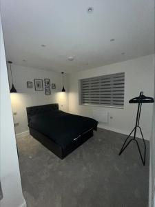 a bedroom with a bed and a table in it at Premium London Apartment - 10 minutes from Wembley Stadium, OVO Wembley Arena in London