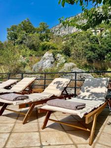 three chaise lounges sitting on top of a patio at Ciborovi Dvori in Bribir