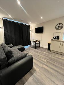 a living room with a couch and a table at Premium London Apartment - 10 minutes from Wembley Stadium, OVO Wembley Arena in London +6 photos