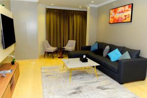 a living room with a couch and a table at Art Suite in Riyadh