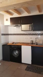 a kitchen with a washing machine and a sink at Maison vue Cité 2 in Carcassonne +64 photos