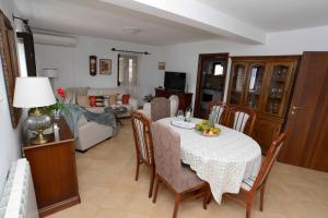 a living room with a dining table and a living room at Lazovic- Apartment by the Sea with Amazing View in Dobrota