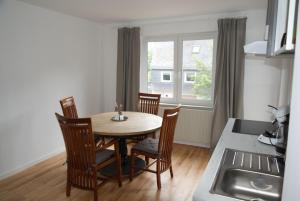 a kitchen with a table and chairs and a sink at Ferienwohnung Frieda in Uhler