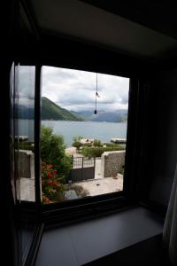 a view of a lake from a window at Lazovic- Apartment by the Sea with Amazing View in Dobrota