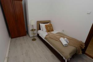 a small bedroom with a bed with towels on it at Lazovic- Apartment by the Sea with Amazing View in Dobrota