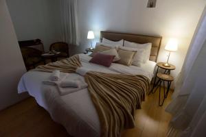 a bedroom with a large bed with towels on it at Lazovic- Apartment by the Sea with Amazing View in Dobrota