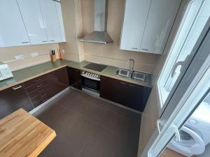 a small kitchen with a sink and a stove at Piso 3 Dormitorios in La Roda +6 photos