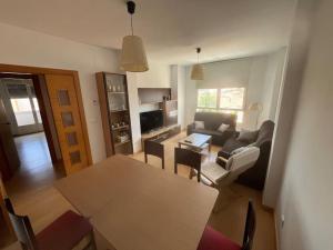 a living room with a table and a couch at Piso 3 Dormitorios in La Roda