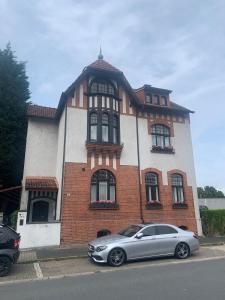 a silver car parked in front of a brick building at Awesome Erichs Finest in Herten