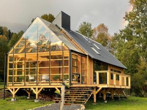 a large wooden house with a black roof at Casa Remanso in Futrono
