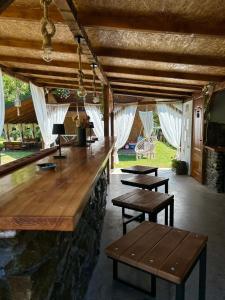a bar with benches and tables in a room at Cabana Oana 5-bedrooms chalet in Arad