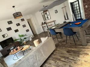 a living room with a couch and a table at A&M Games and spa in Charleville-Mézières +24 photos