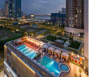 a hotel with a pool on top of a building at Songdo Halla Westernpark-SeaViewRoom Hotel-바다전망 in Incheon