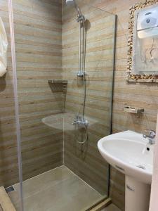 a bathroom with a shower and a sink at Blue Waves Villa Ras Al Hikma in Marsa Matruh