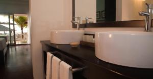 a bathroom with two sinks on a counter at Sandy Haven Resort in Negril