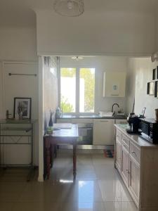 a kitchen with a table in the middle of it at Eco-refuge la Nuit étoilée, Calme, Wifi,5 mn Centre à pied, parking gratuit, parking vélo in Arles