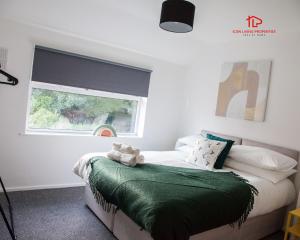 a bedroom with a bed with a window at Spacious 7-Bed Home for Contractors & Families in St Helens in Saint Helens
