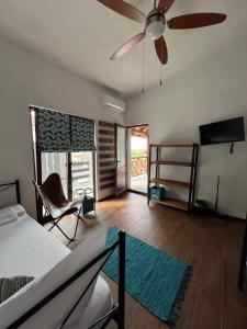 a bedroom with a bed and a ceiling fan at Guest House Kalina,Studio 3 in Ammouliani