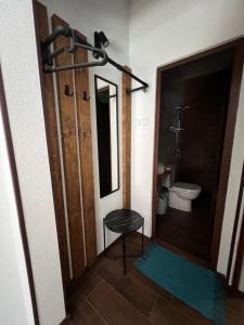 a bathroom with a toilet and a door with a stool at Guest House Kalina,Studio 3 in Ammouliani