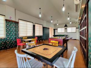 a room with a ping pong table and chairs at Serene 43, Karjat 3 BHK Villa, Wifi, Plunge Pool in Karjat