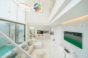 a living room with a pool and a tv at Andaman Villa 15 minutes from Bangtao Beach in Phuket Town