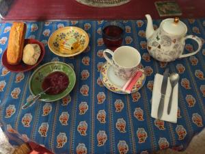a table topped with a blue table cloth with a tea set at Maison Bonhomme in Cusset