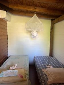 two beds in a room with two babies on them at Les Alpinias in Sainte-Anne +8 photos