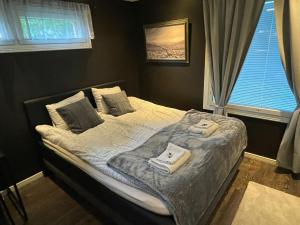 a bedroom with a bed with two towels on it at Resort Kurjenoja Homestay in Rovaniemi