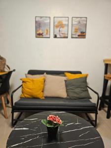 a living room with a couch with pillows and a table at Q Workcation WFH Staycation in Manila