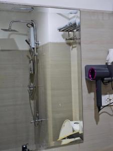 a shower in a bathroom with a glass door at Q Workcation WFH Staycation in Manila
