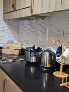 two pots and pans sitting on a kitchen counter at Q Workcation WFH Staycation in Manila