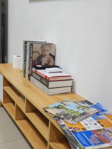 a pile of books sitting on a wooden table at Q Workcation WFH Staycation in Manila