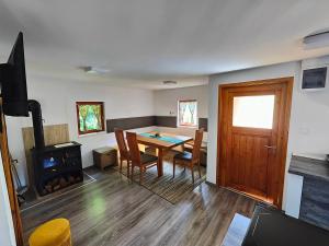 a living room with a table and a fireplace at Holiday Home Sveti Martin in Kobilje