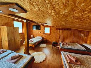 a room with two beds in a wooden cabin at Holiday Home Sveti Martin in Kobilje