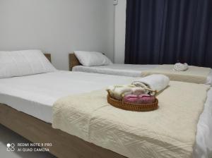 a dog laying in a basket on two beds at Semenyih Setia Ecohill 2 Free Wifi in Beranang