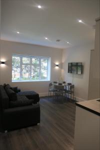 a living room with a couch and a table at Exclusive London Apartment - Wembley Stadium, OVO Wembley Arena in London +2 photos