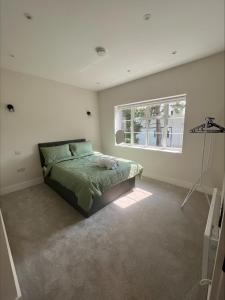 a bedroom with a bed and a window at Exclusive London Apartment - Wembley Stadium, OVO Wembley Arena in London