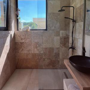 a bathroom with a sink and a window at MAYA- Villas On The Lake in Curchi +99 photos