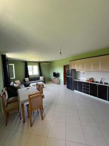 a large living room with a couch and a table at The White Villa in Hamallë