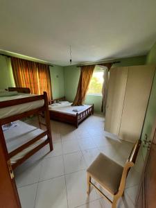 a room with two bunk beds and a window at The White Villa in Hamallë
