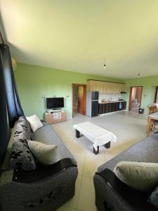 a living room with a couch and a coffee table at The White Villa in Hamallë