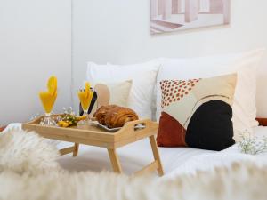 a table with a tray of food on a couch at La Petite Vienna - Vienna authentica in Vienne