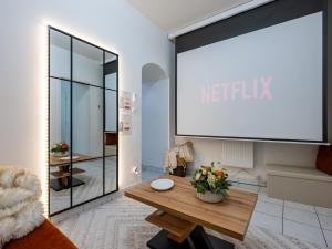 a living room with a large white sign on the wall at La Petite Vienna - Vienna authentica in Vienne +8 photos